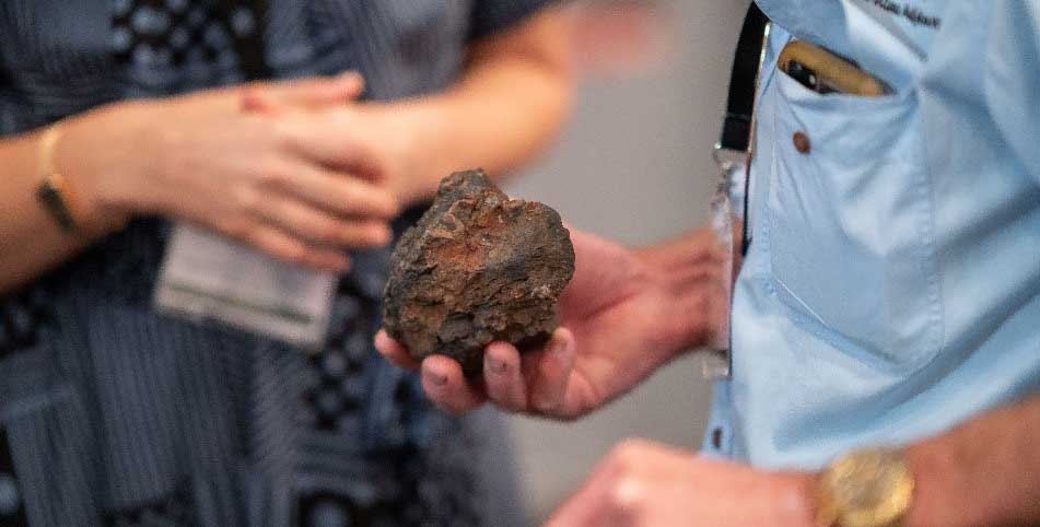 Man studying a rock