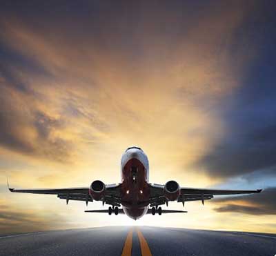 Plane taking off at sunset