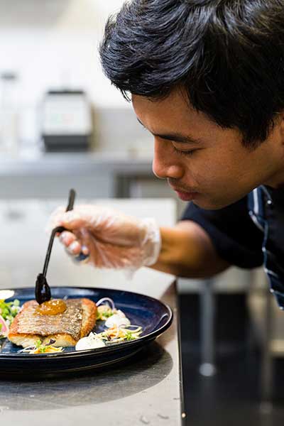 Student preparing plate of food