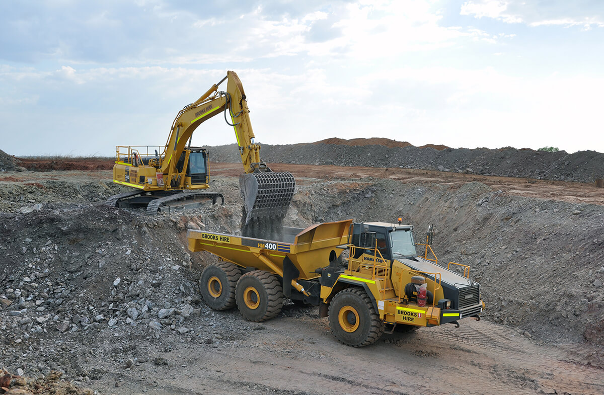 Excavator loading dirt into tip truck