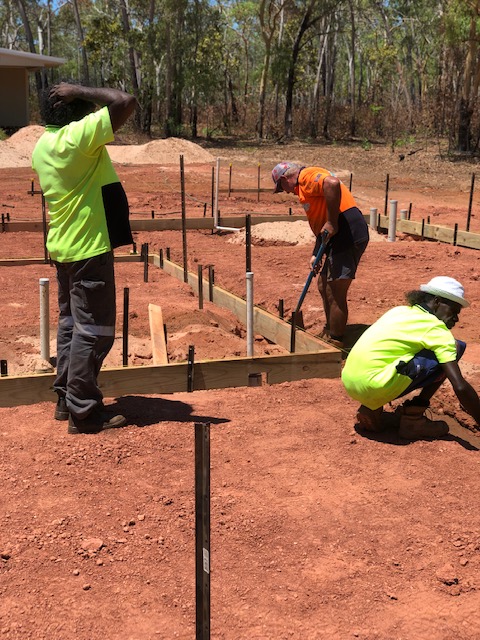 Workmen preparing a house slab