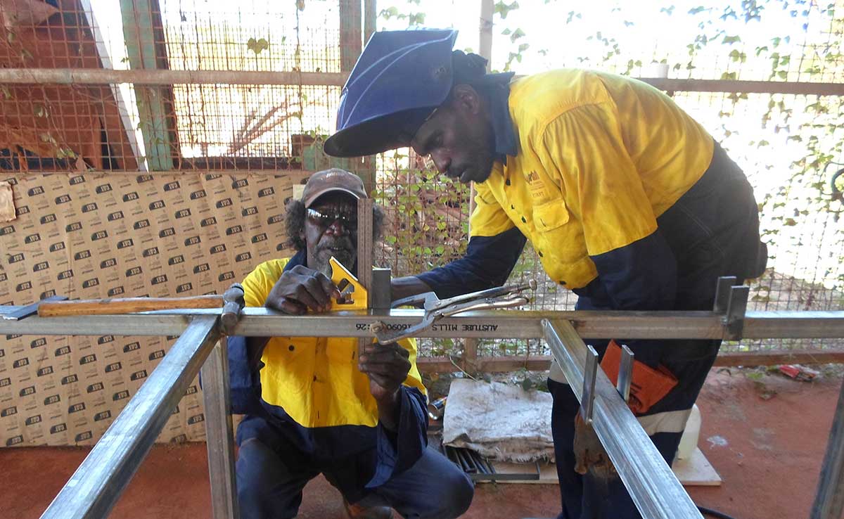 Workmen measuring steel