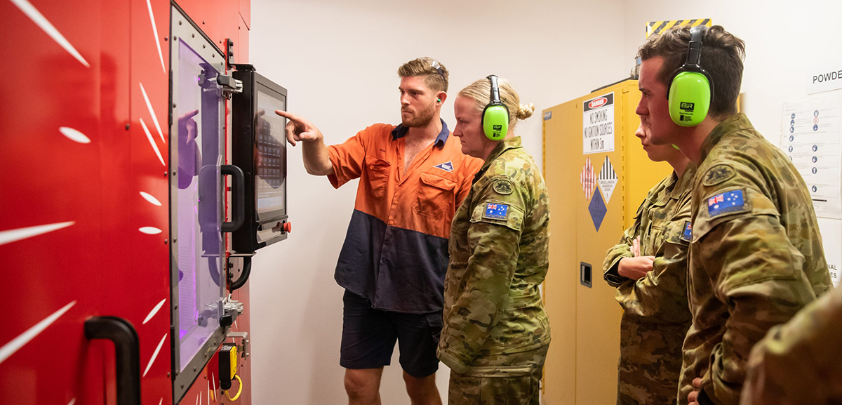 Australian Army staff viewing the Spee3D printer