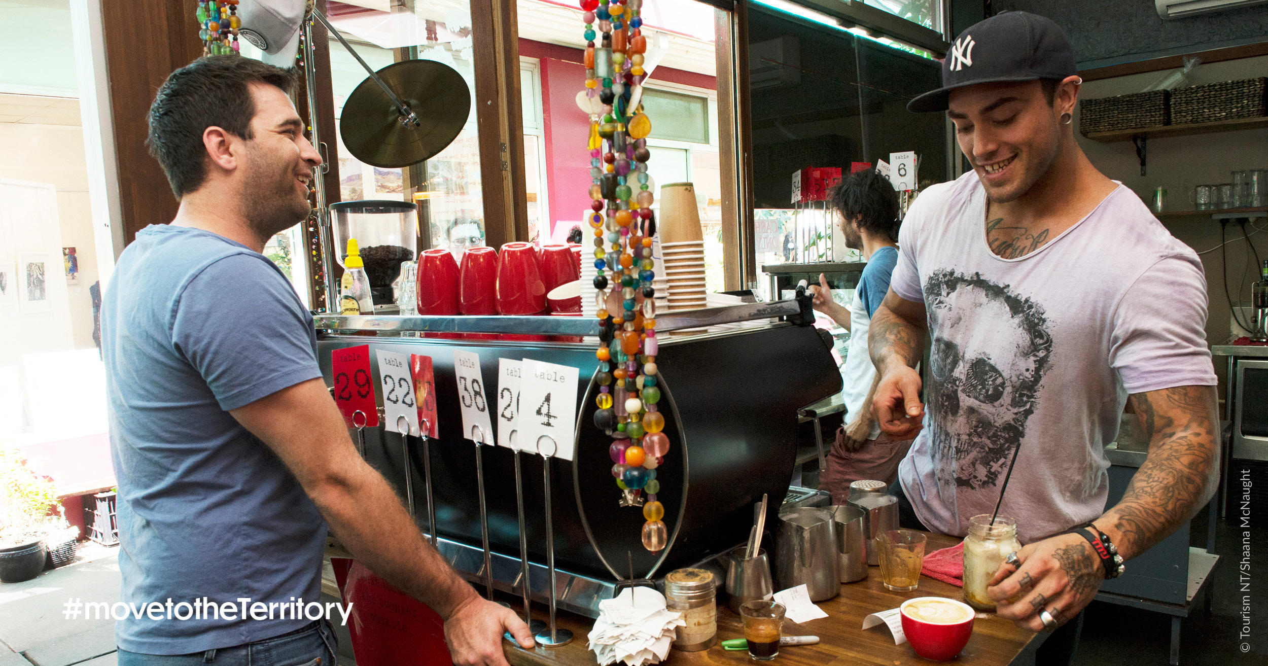 A barista making coffee in front of a customer