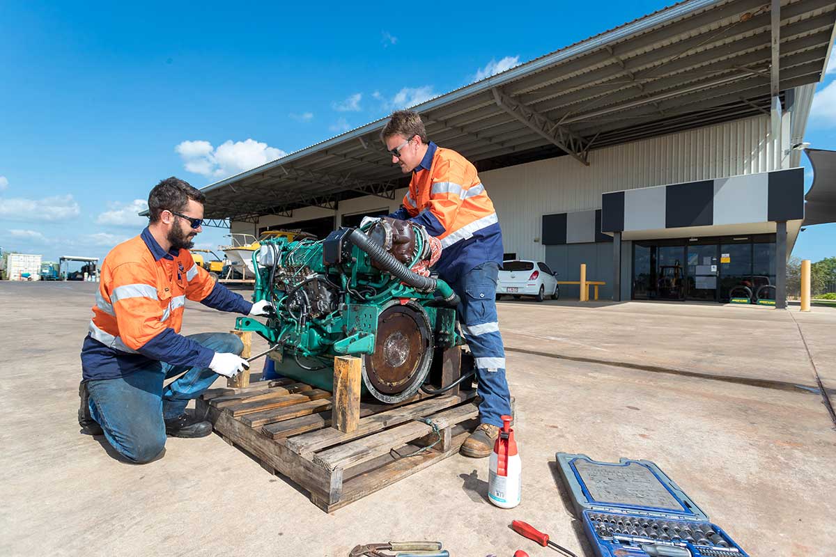 Two men working on an engine