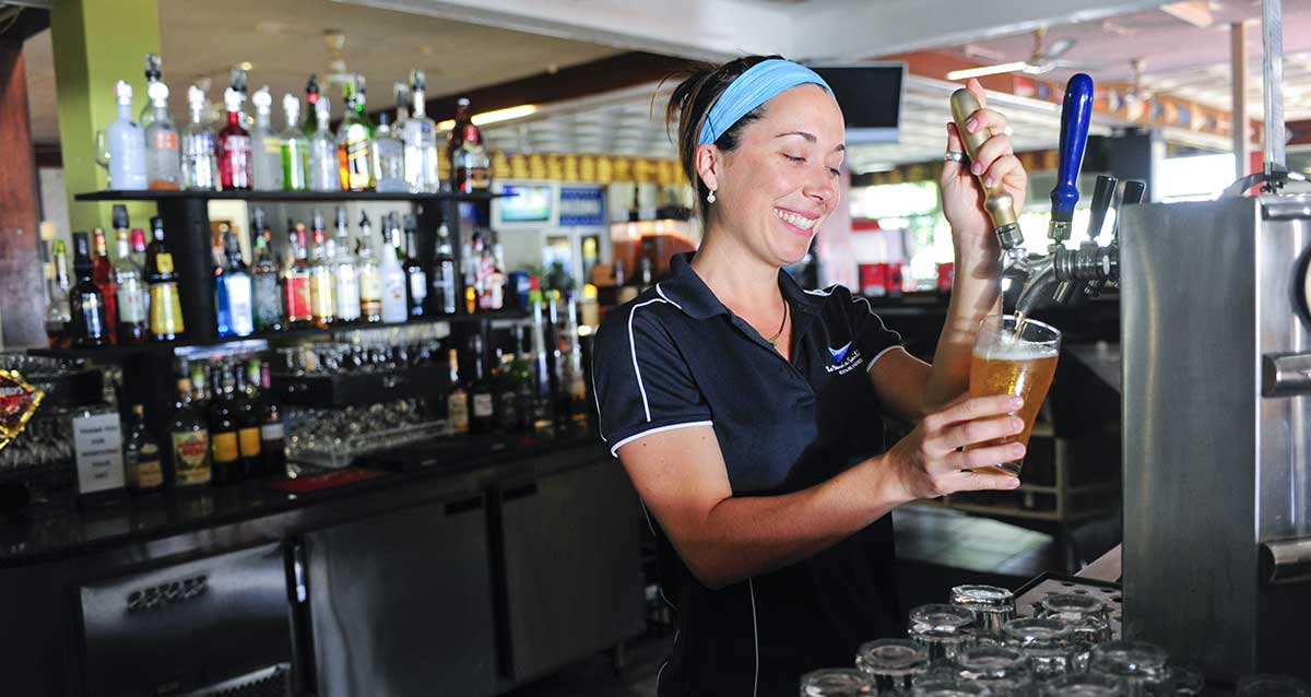 Bar person pouring beer