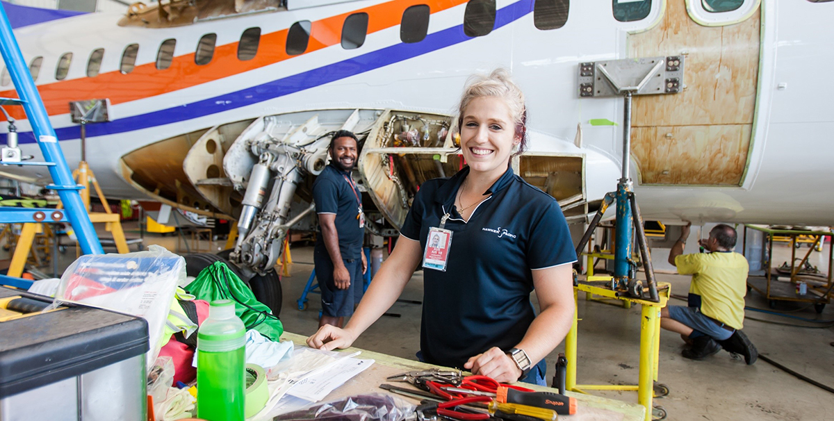 Young woman working on an aeroplane