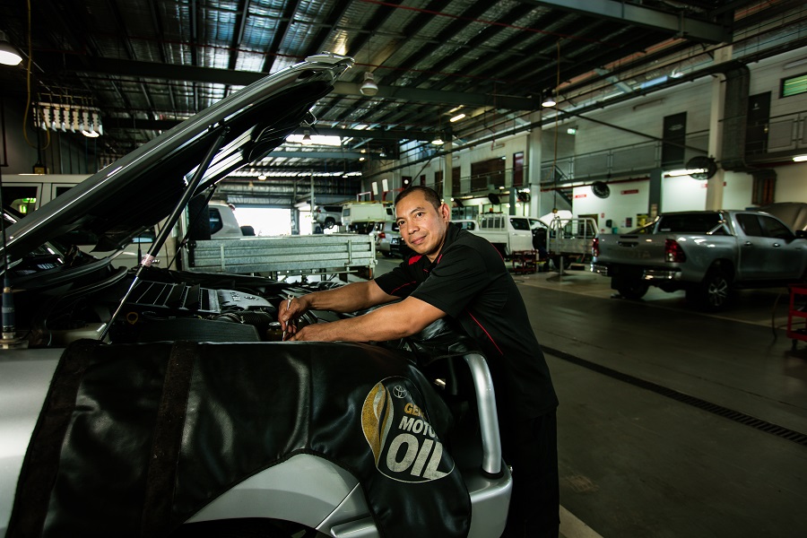 A mechanic in front of a vehicle