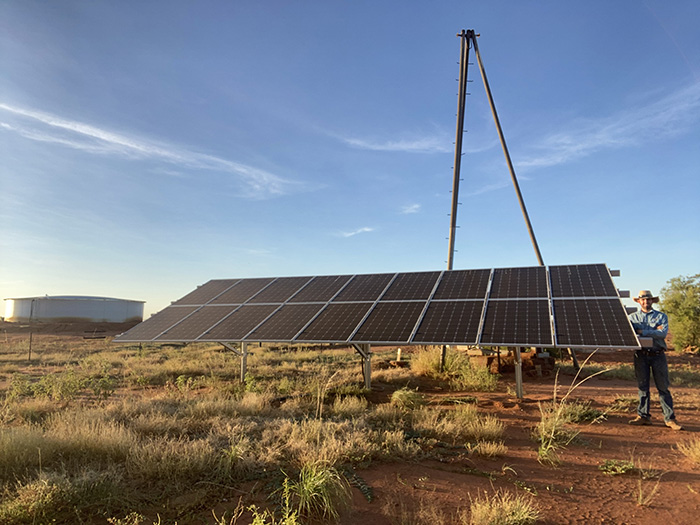 Epenarra station hand John Delaforce standing next to the one of the new solar installations