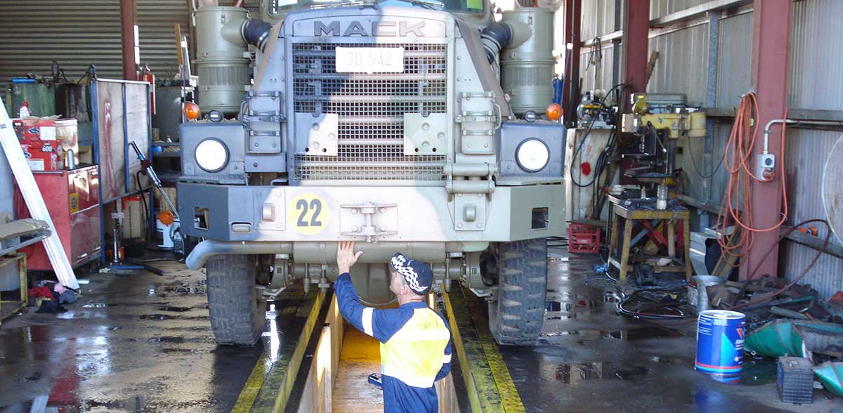 Mechanic fixing an army truck