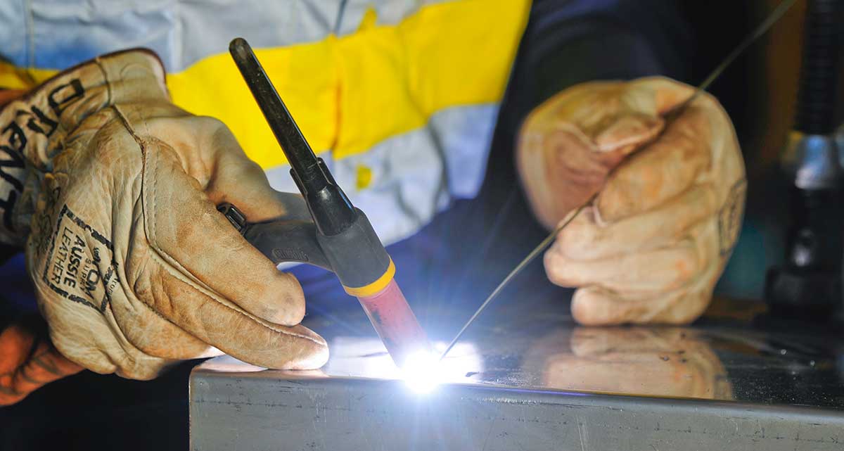 Hands with gloves welding