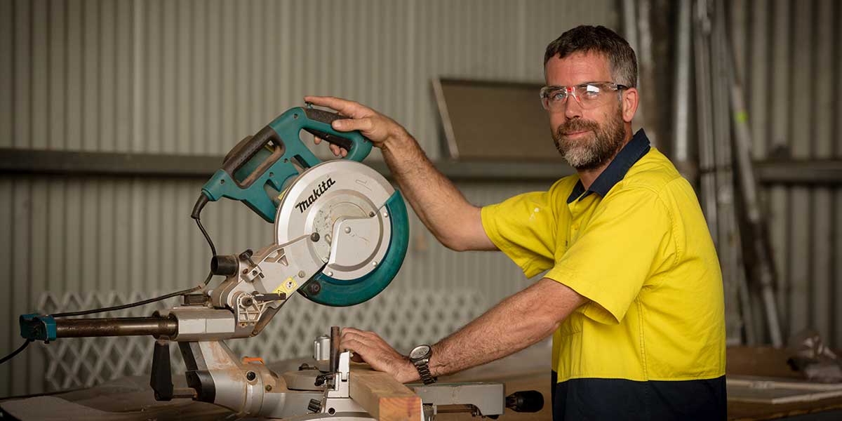 Tradesman working with a drop-saw