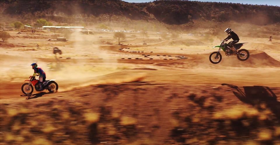 Motocross bikes being ridden through the desert