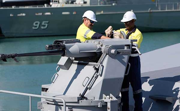 Two men working on a Defence ship