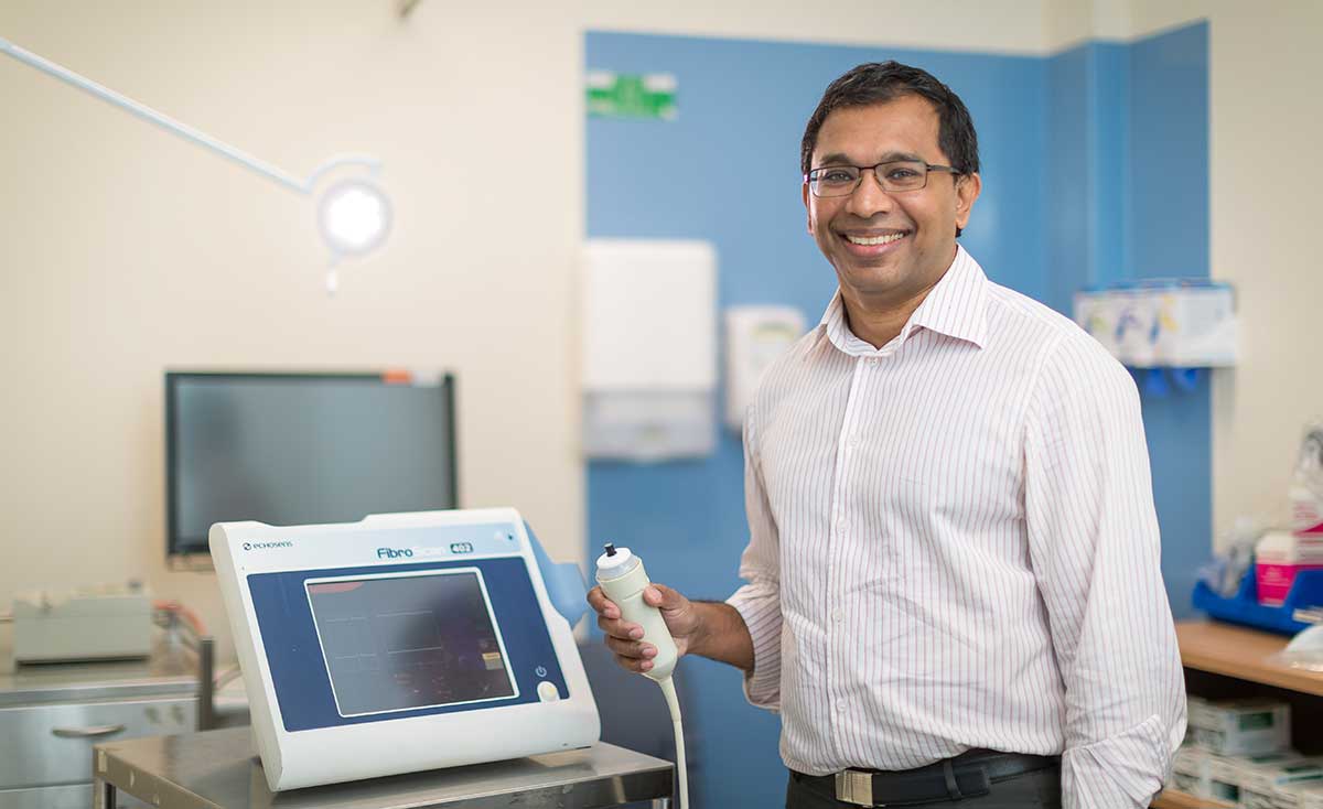 Man standing beside medical equipment