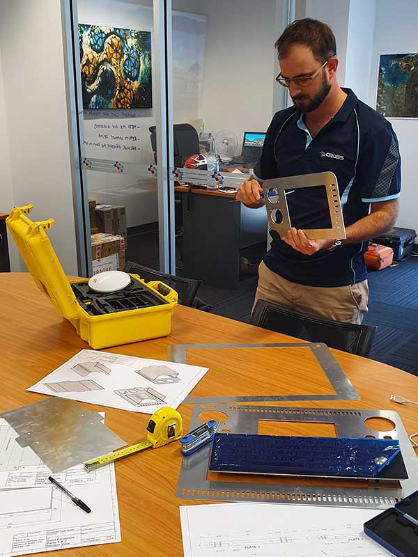 Man working on the components of a mobile laser mapping system