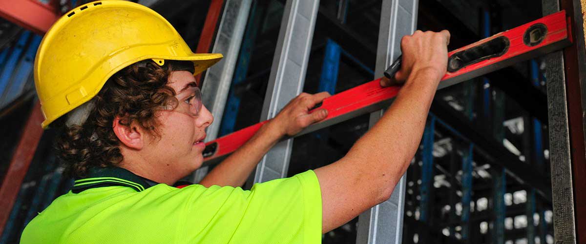 Young tradesman working on a building